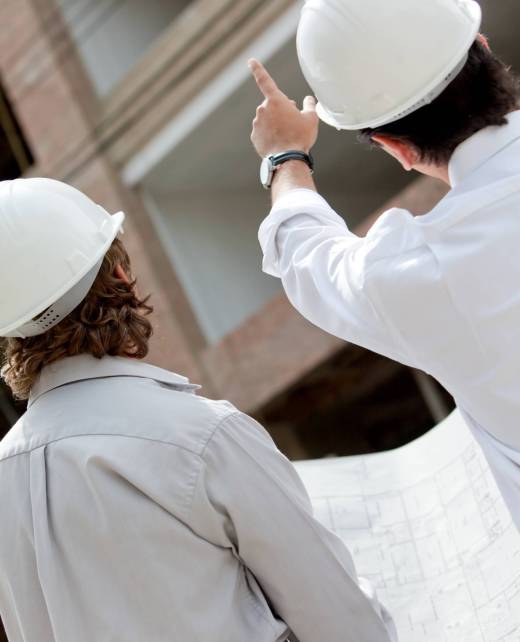 architects-with-blueprints-looking-at-a-building-2025-10-13-05-40-38-utc